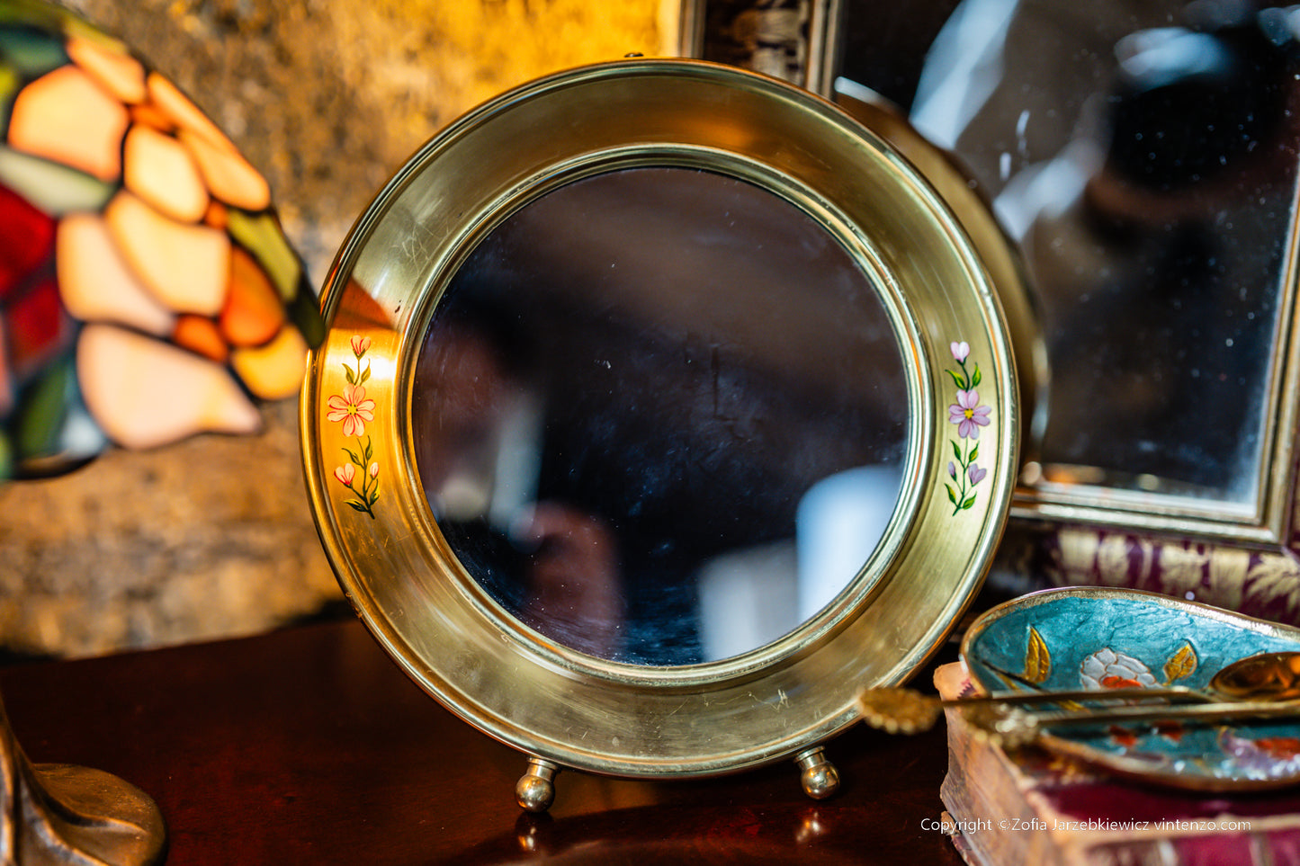 Small Vintage Mirror with a Gold Frame and Small Flowers on the Sides