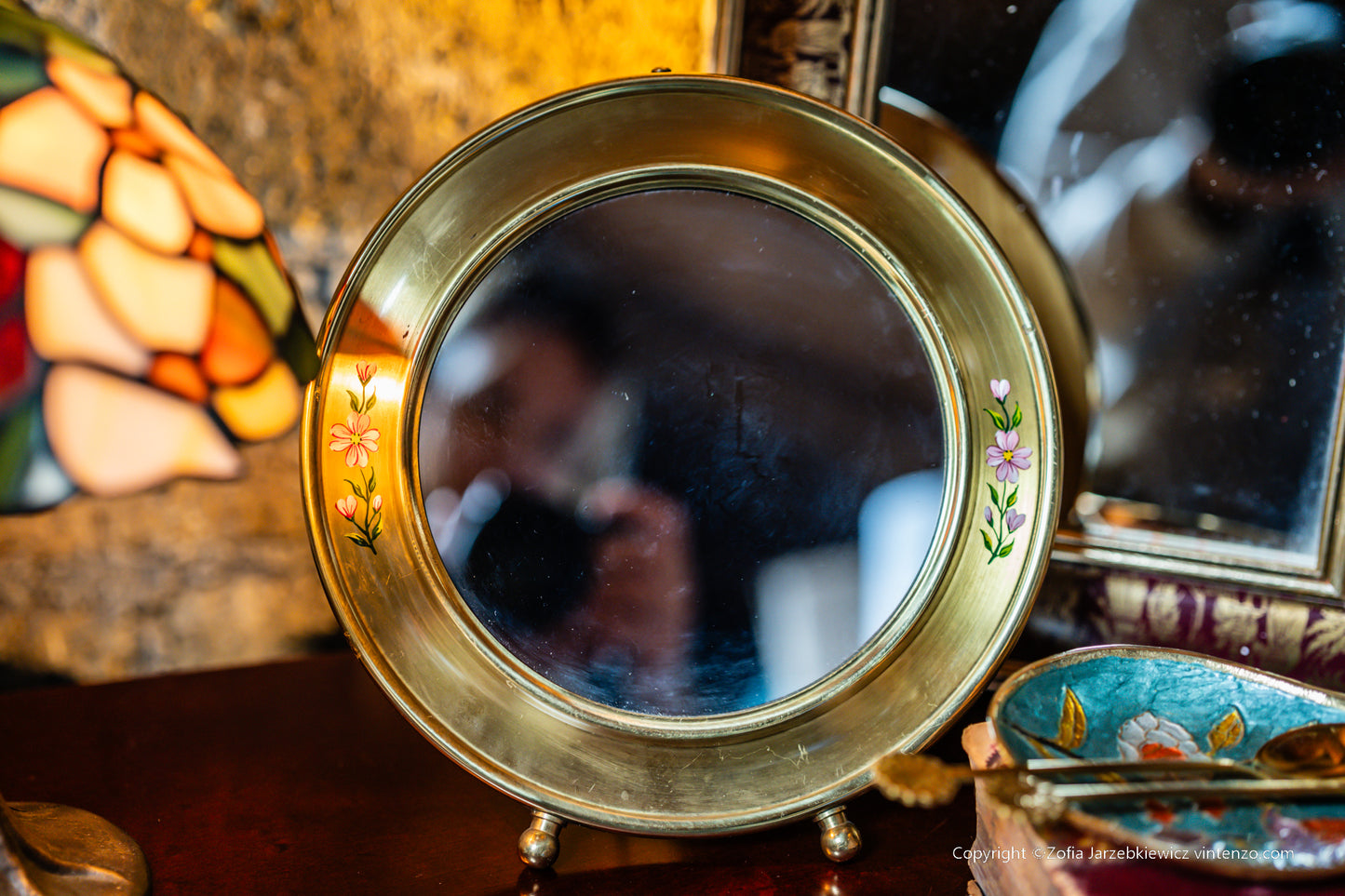Small Vintage Mirror with a Gold Frame and Small Flowers on the Sides