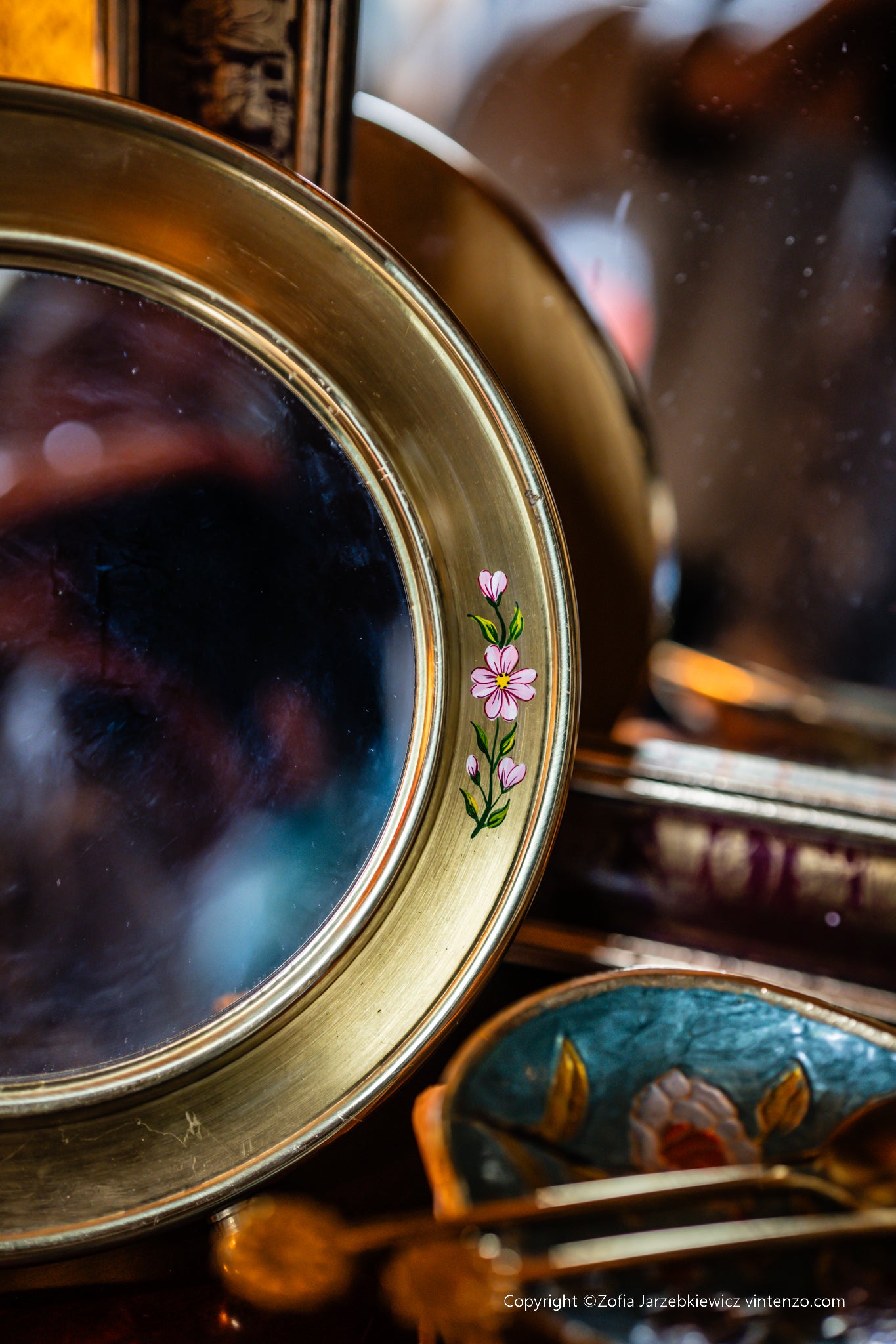 Small Vintage Mirror with a Gold Frame and Small Flowers on the Sides