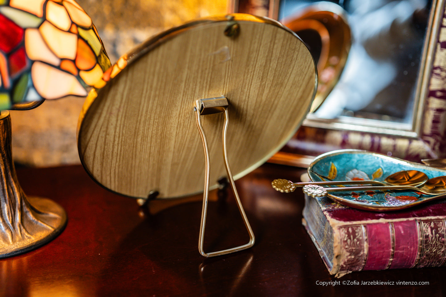 Small Vintage Mirror with a Gold Frame and Small Flowers on the Sides