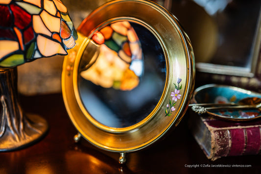 Small Vintage Mirror with a Gold Frame and Small Flowers on the Sides